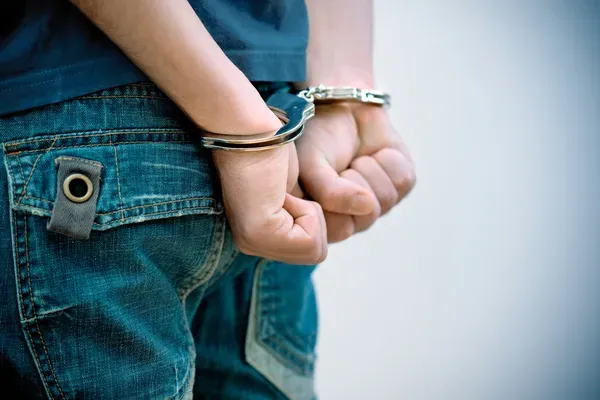 depositphotos_7149143-stock-photo-young-man-in-handcuffs